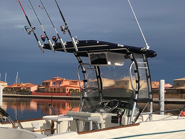 a boat with fishing poles on the water